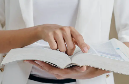 Person flipping through the pages of an open book